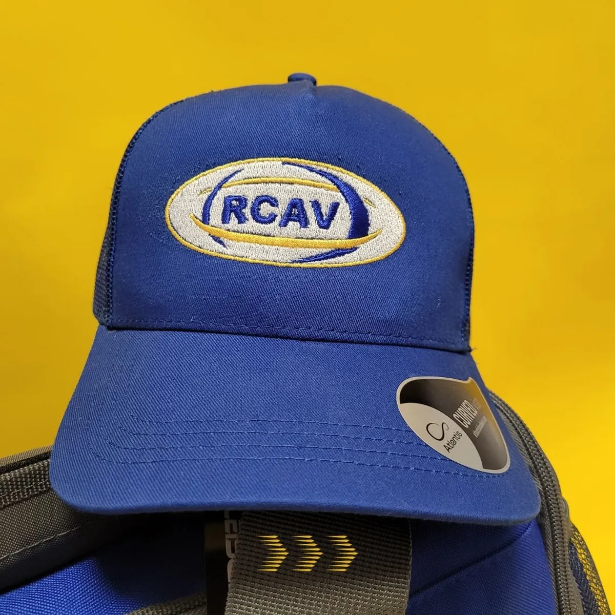 Casquette bleue à filet, brodée de l'écusson RCAV en fil blanc, bleu et jaune